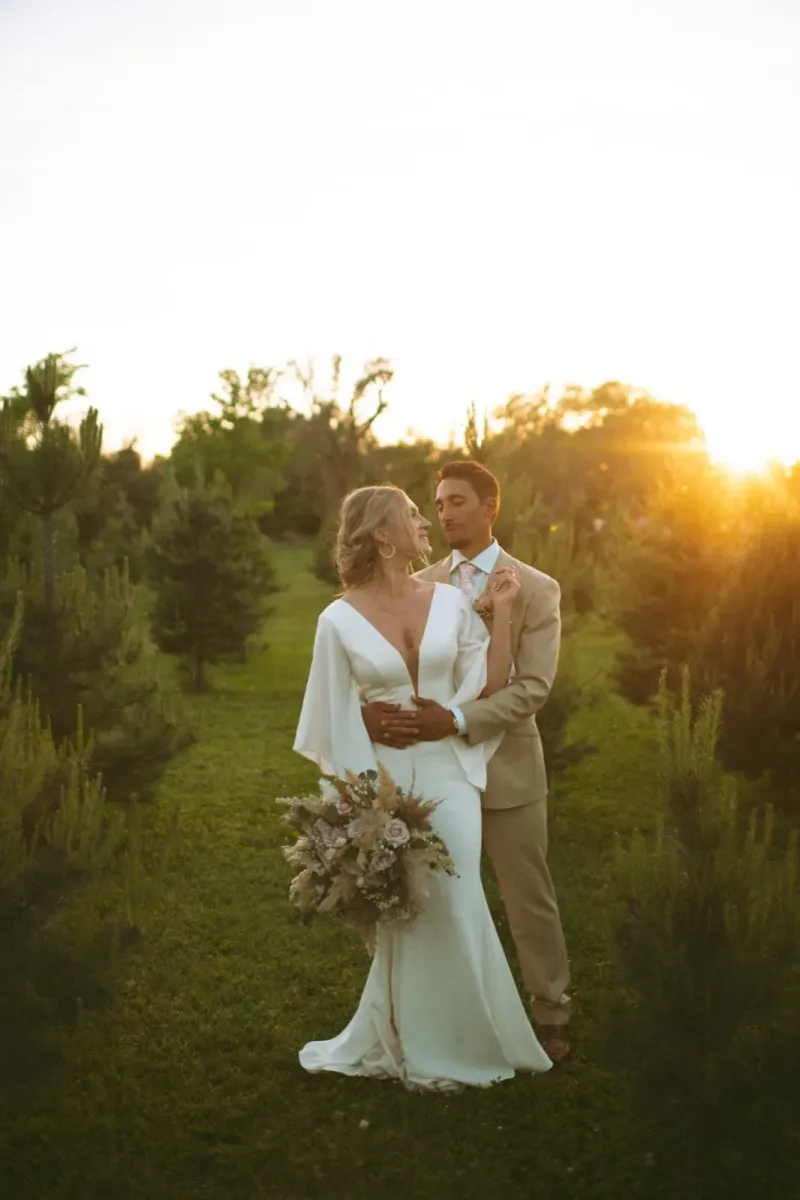 Romantic sunset wedding portrait of couple at golden hour