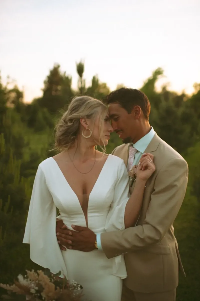 Intimate bridal couple portrait with blonde bride in modern wedding gown