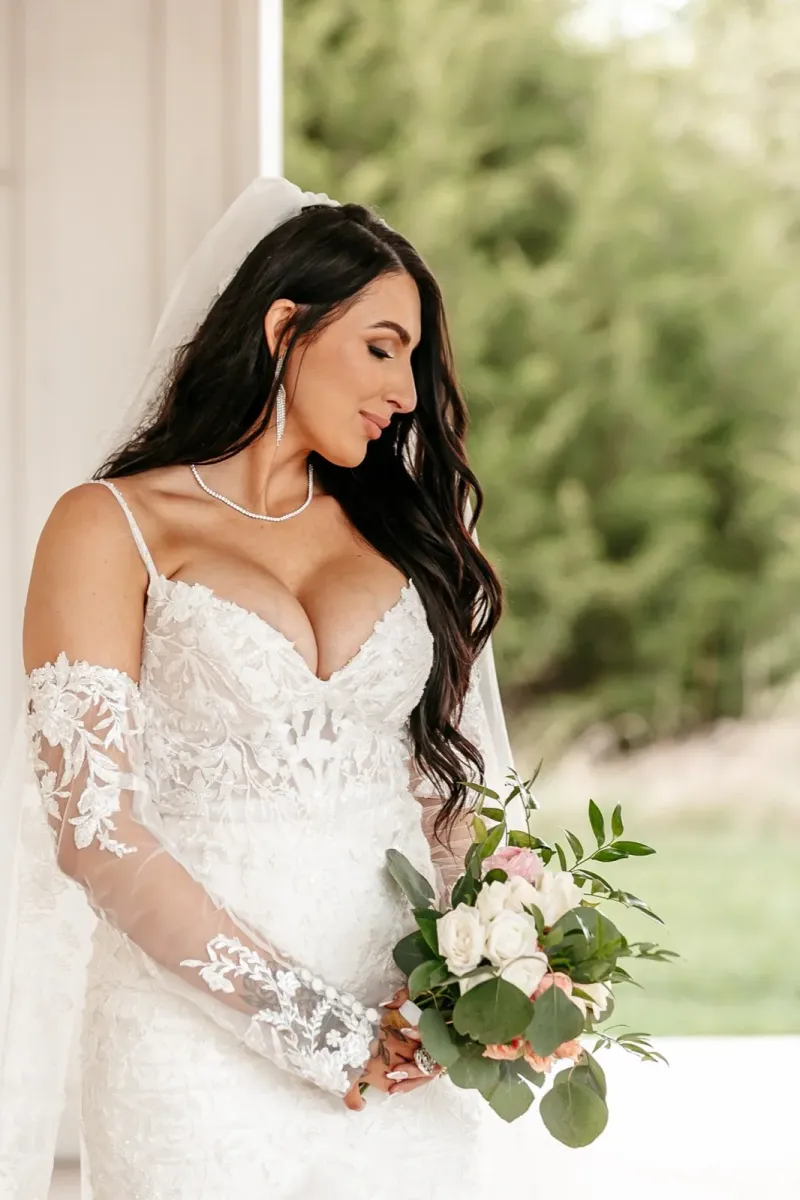 Bride in off-shoulder lace wedding gown with cathedral veil