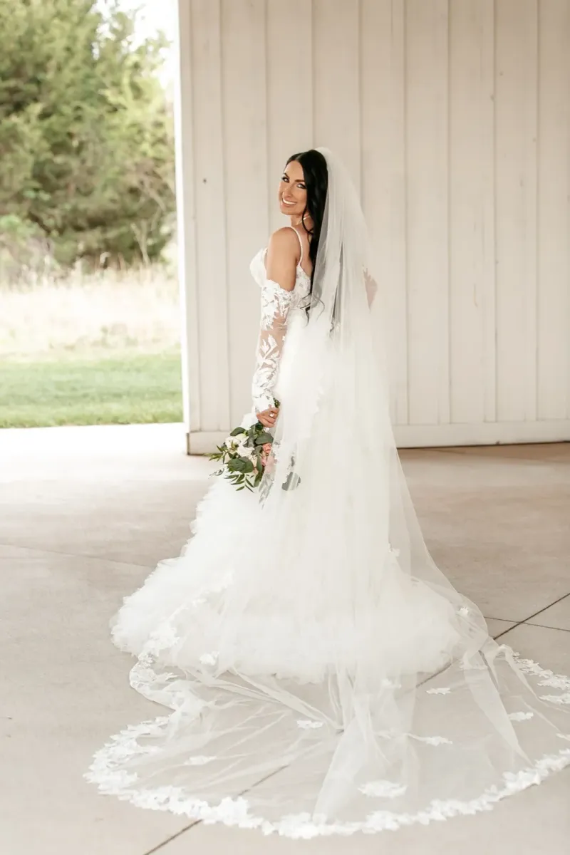 Full-length bridal portrait with dramatic cathedral train and veil