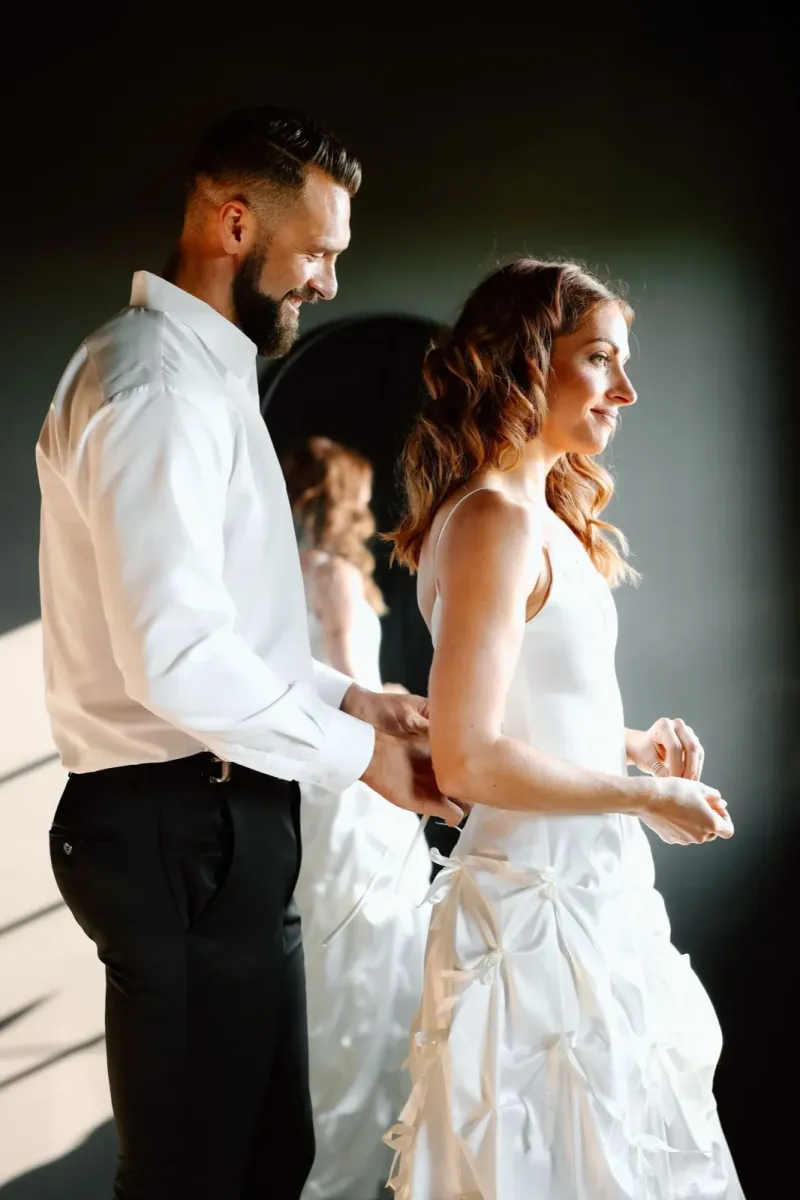Wedding couple first look with bride in corset back wedding dress