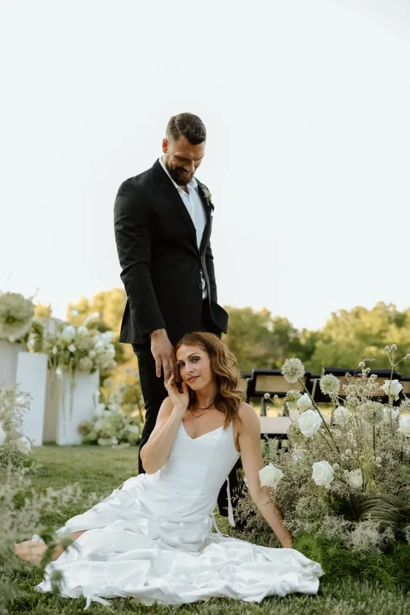 Romantic outdoor wedding portrait with bride and groom at ceremony site