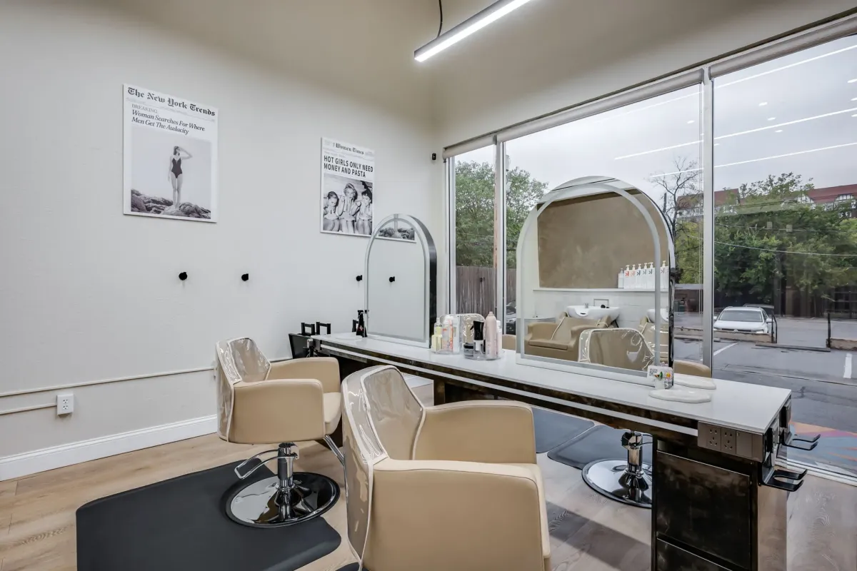 Bright salon styling station with large mirrors and minimalist vintage decor