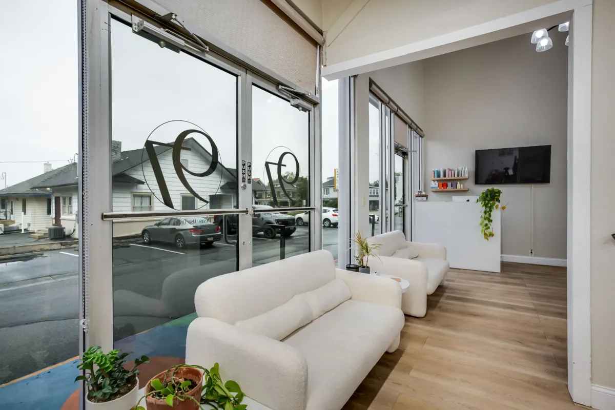 Modern salon waiting area with comfortable seating and natural light