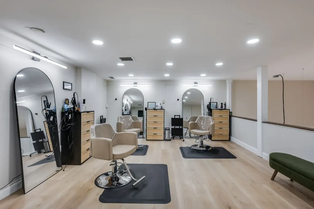 Upstairs salon suite with multiple styling stations and natural light