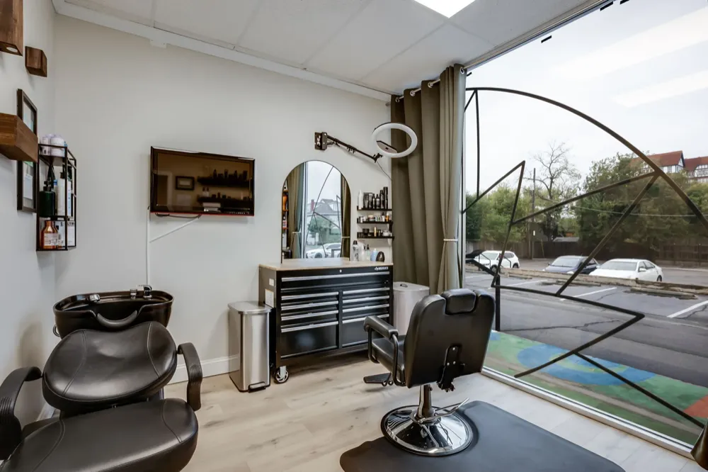 Salon suite with shampoo bowl styling chair and floor-to-ceiling windows